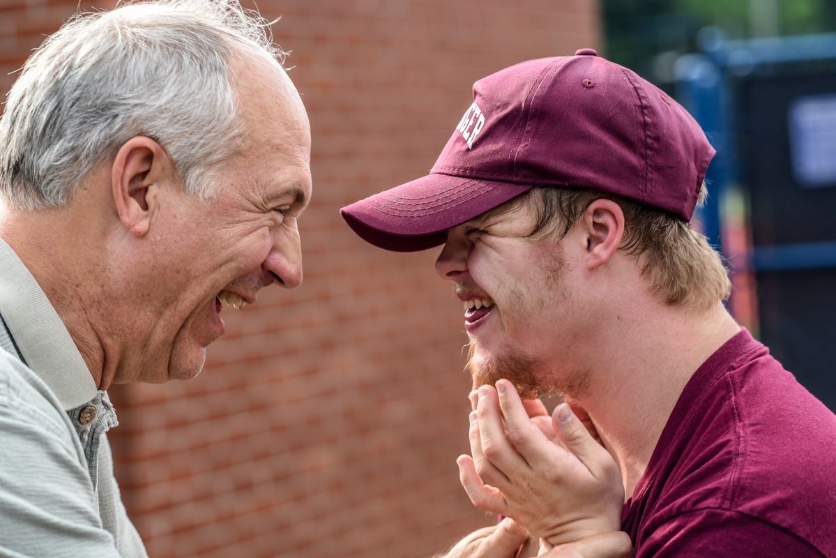 Coach and member sharing a joyful moment together outdoors