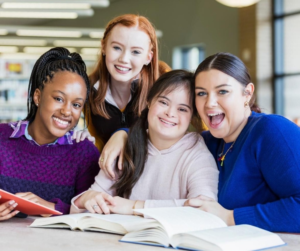Diverse group of adults with IDD learning together in a library setting