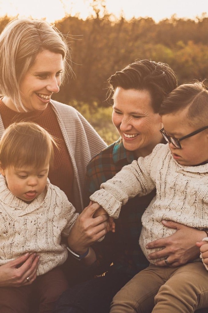 Diverse group of adults laughing together in an inclusive community setting