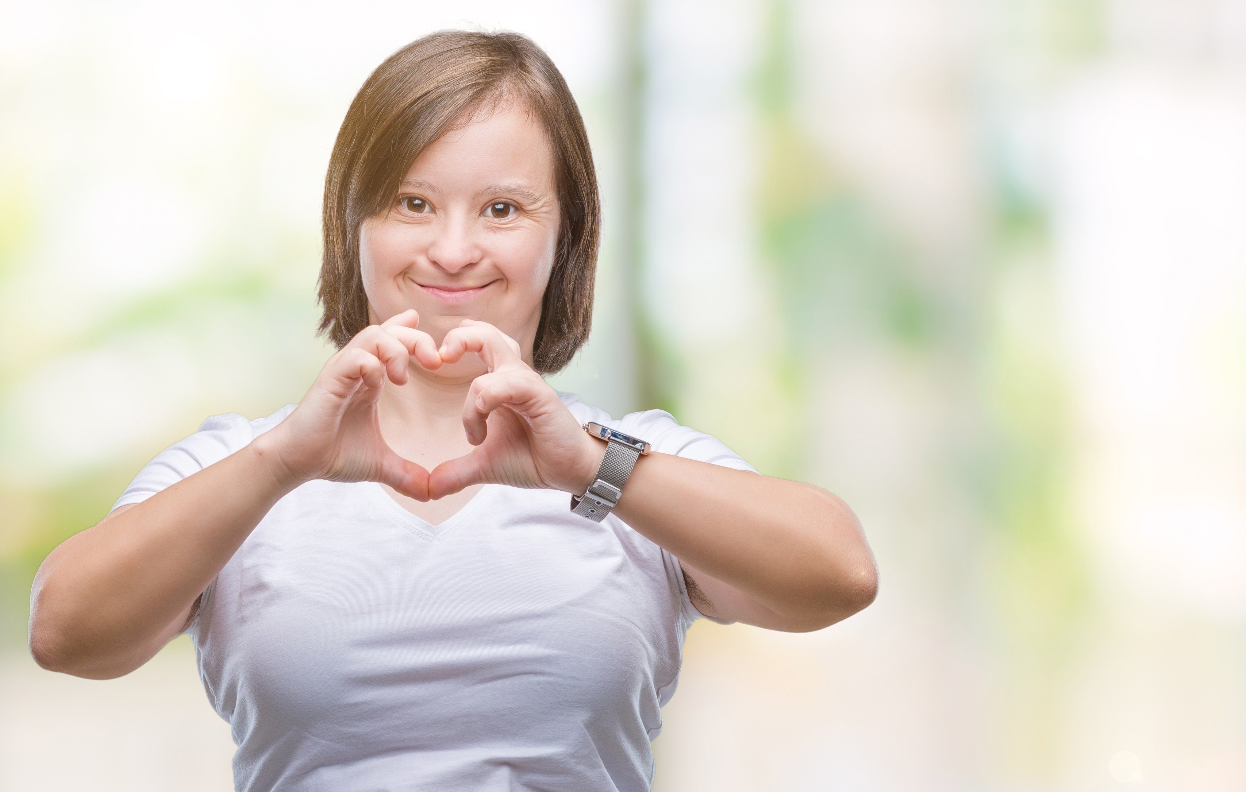 women creating the shape of a heart with her hands